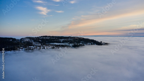 Arial: Photo shot with a drone. Fog in the valley below. Norway, Oslo, Holmenkollen.