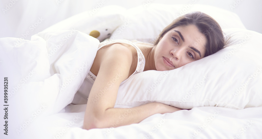 beautiful young woman basking in bed in the morning. Beautiful Model face looks sexy in camera beautiful young woman basking in bed in the morning. Beautiful Model face looks sexy in camera