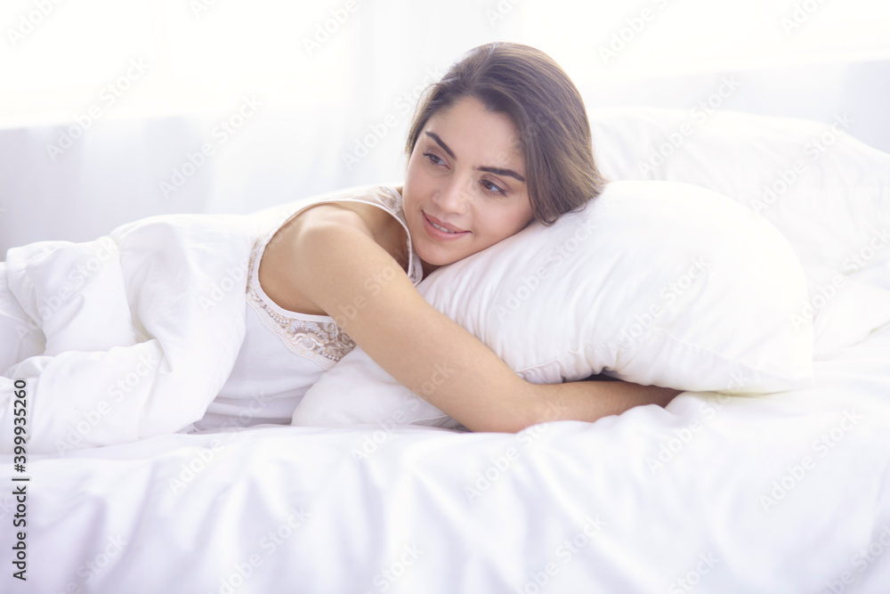 beautiful young woman basking in bed in the morning. Beautiful Model face looks sexy in camera beautiful young woman basking in bed in the morning. Beautiful Model face looks sexy in camera