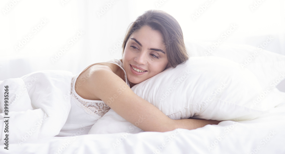 beautiful young woman basking in bed in the morning. Beautiful Model face looks sexy in camera