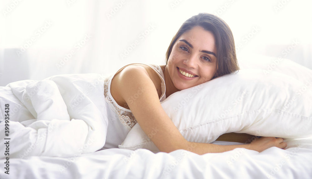 beautiful young woman basking in bed in the morning. Beautiful Model face looks sexy in camera beautiful young woman basking in bed in the morning. Beautiful Model face looks sexy in camera