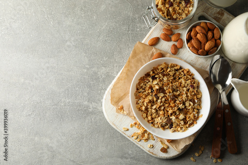 Concept of tasty breakfast with granola on gray background