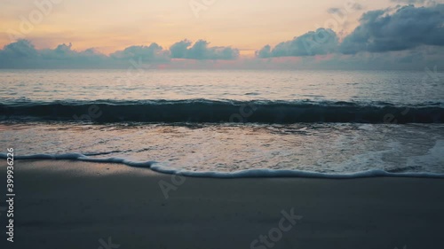 Tropical deserted sandy beach at sunrise. The sound of the surf