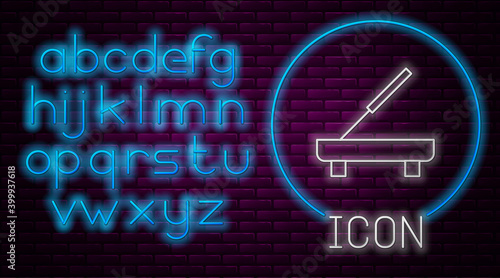 Glowing neon line Scented spa stick on a wooden stand icon isolated on brick wall background. Incense stick. Cosmetic procedure aromatherapy. Neon light alphabet. Vector.