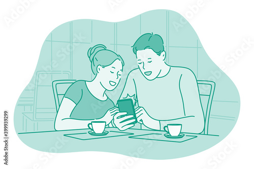Smartphone, online communication, chatting concept. Young couple sitting at home drinking tea with smartphone in hands, chatting, searching information in internet, communicating online 