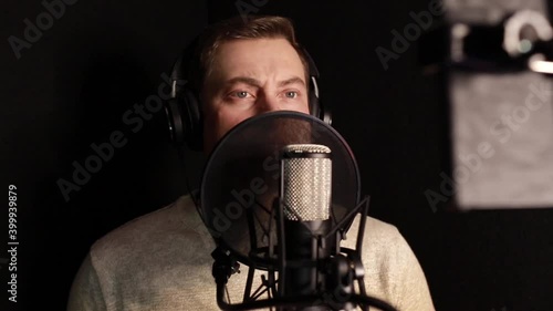 A professional announcer makes a recording in the studio