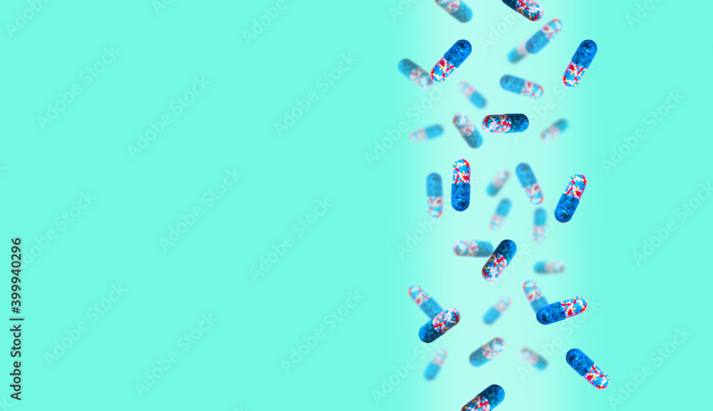 Colored pills are falling against a colored background. Medicine and healthcare concept