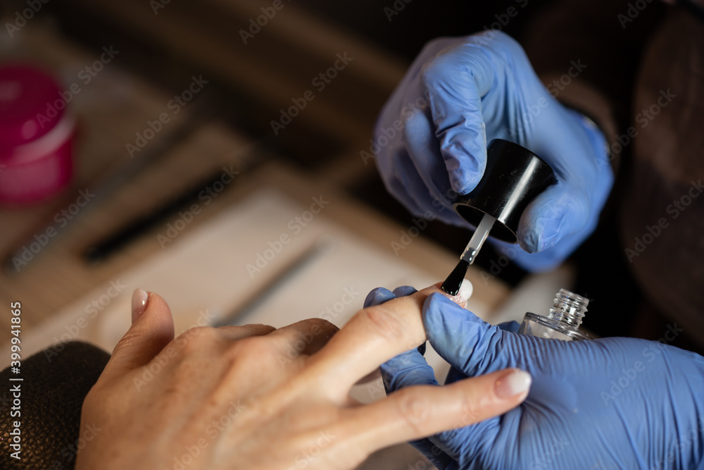 Closeup shot of a woman in a nail salon receiving a manicure - obrazy, fototapety, plakaty 