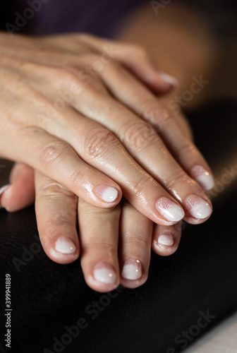 Woman in a nail salon showing her finished nails