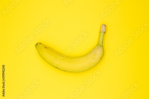 Yellow banana on color background abstract food photo