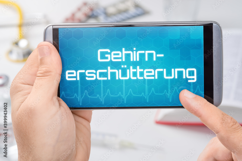 Smartphone mit dem Text Gehirnerschütterung auf dem Display Smartphone mit dem Text Gehirnerschütterung auf dem Display