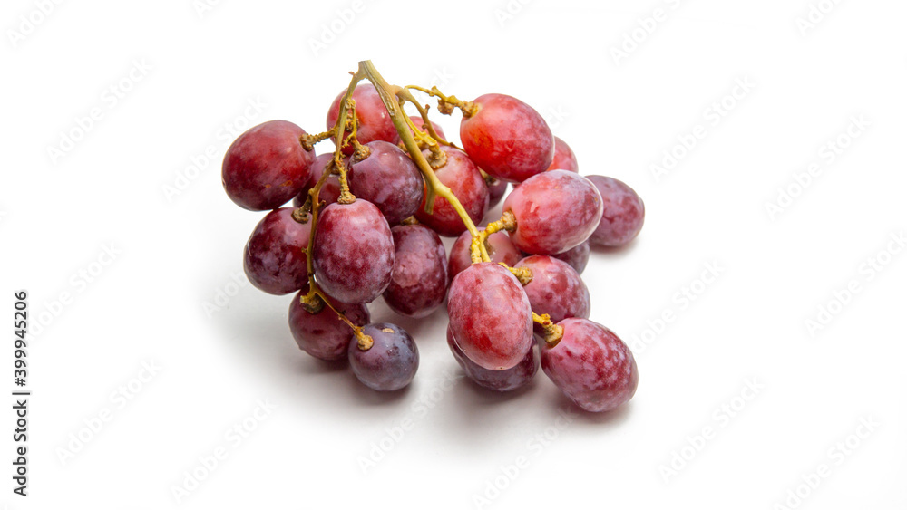 Close up a bunch of fresh red grapes on isolated white background.