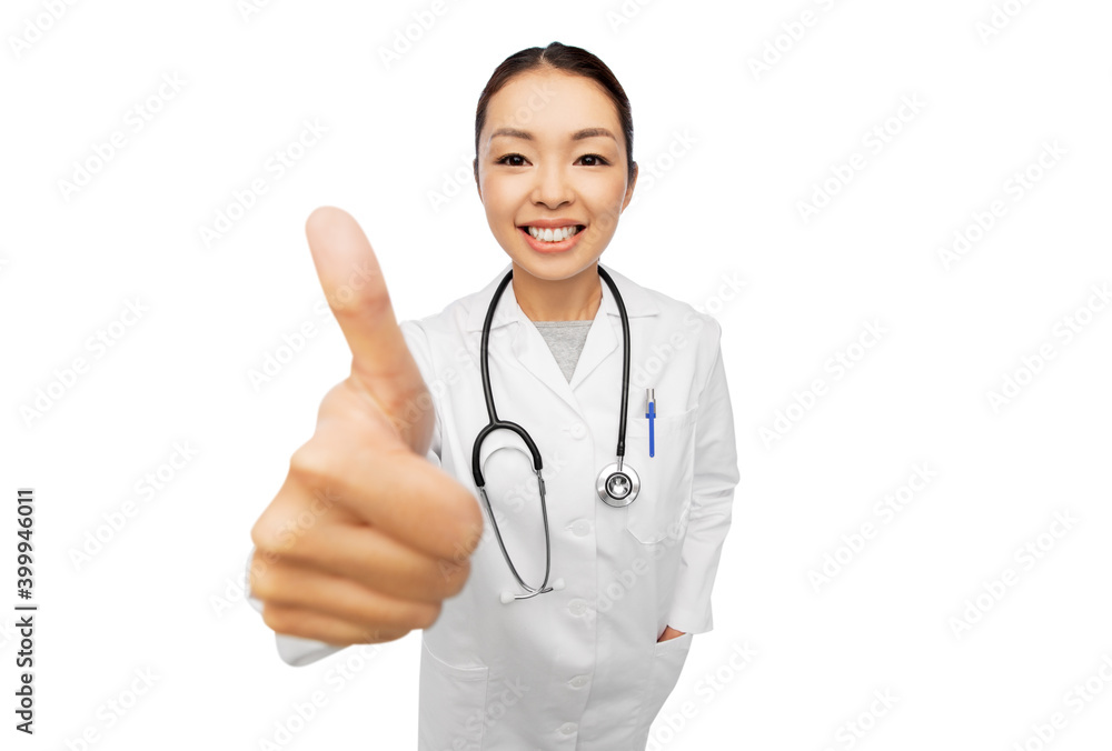 medicine, profession and healthcare concept - happy smiling asian female doctor in white coat with stethoscope showing thumbs up medicine, profession and healthcare concept - happy smiling asian female doctor in white coat with stethoscope showing thumbs up