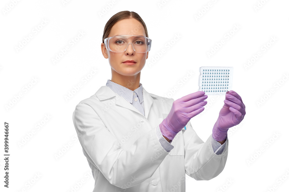 science, chemistry and people concept - young female scientist in goggles with chemical sample or vaccine science, chemistry and people concept - young female scientist in goggles with chemical sample or vaccine
