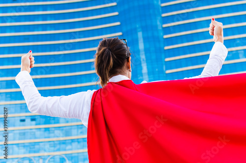 business woman with a super hero cape. rear view