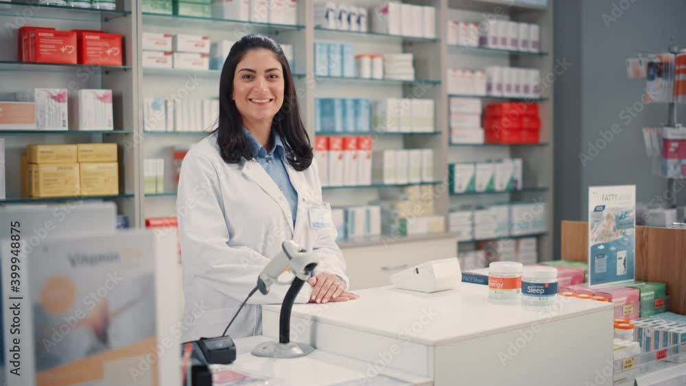 Pharmacy Drugstore Checkout Cashier Counter: Portrait of Beautiful Young Latin Female Pharmacist Looks at the Camera, Smiles Charmingly. Store with Medicine, Drugs, Vitamins, Health Care Products Pharmacy Drugstore Checkout Cashier Counter: Portrait of Beautiful Young Latin Female Pharmacist Looks at the Camera, Smiles Charmingly. Store with Medicine, Drugs, Vitamins, Health Care Products