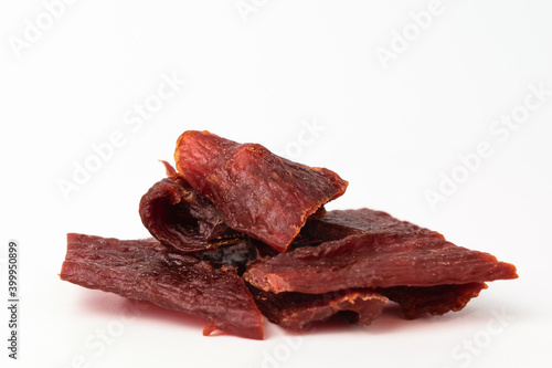 Foto Beef jerky on white background