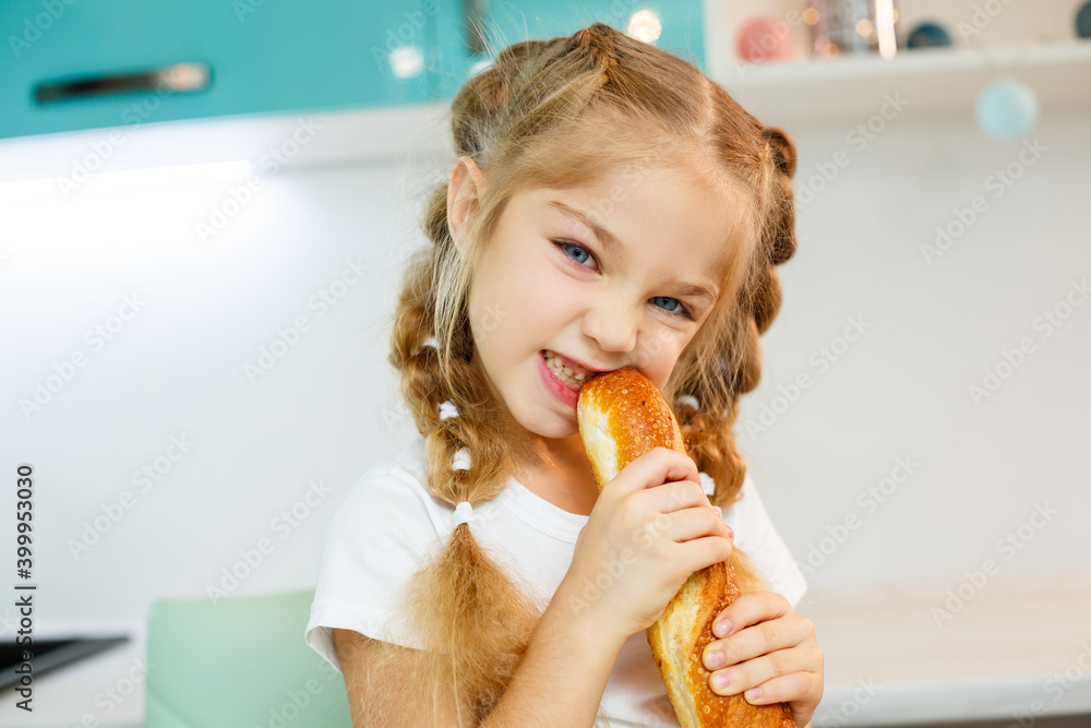 Portrait of a little blonde girl biting a fresh baguette Portrait of a little blonde girl biting a fresh baguette