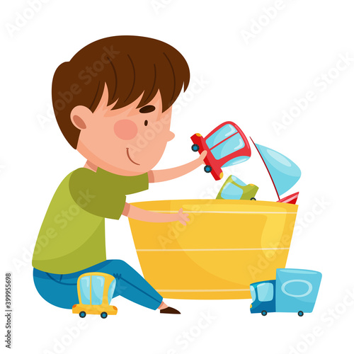 Happy Boy Sitting on Floor and Playing with Different Toys in Playroom Vector Illustration