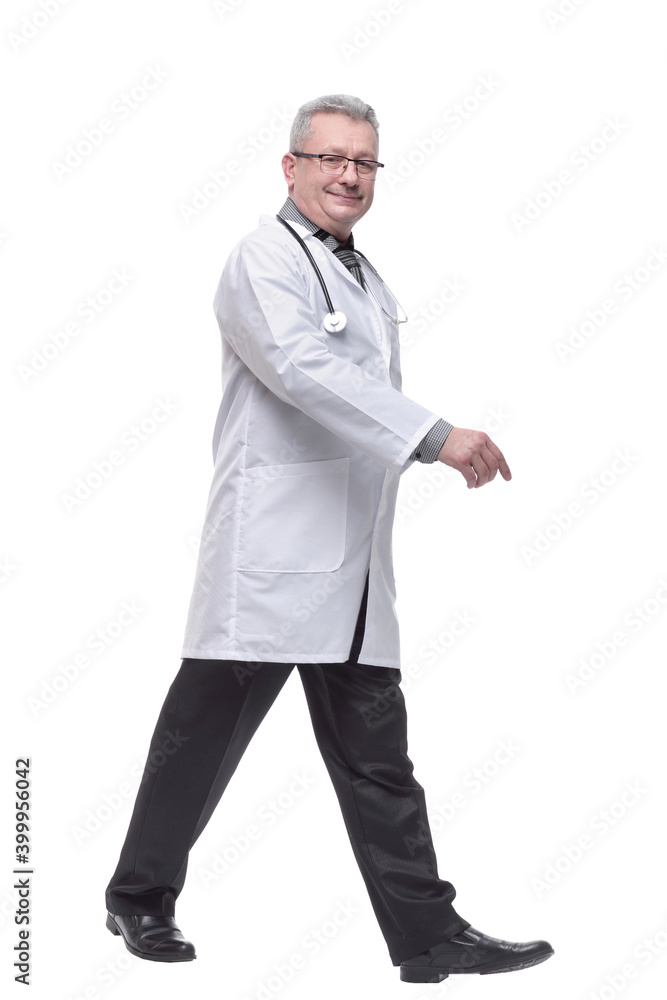 Walking mature doctor, side view. Full length studio shot Walking mature doctor, side view. Full length studio shot