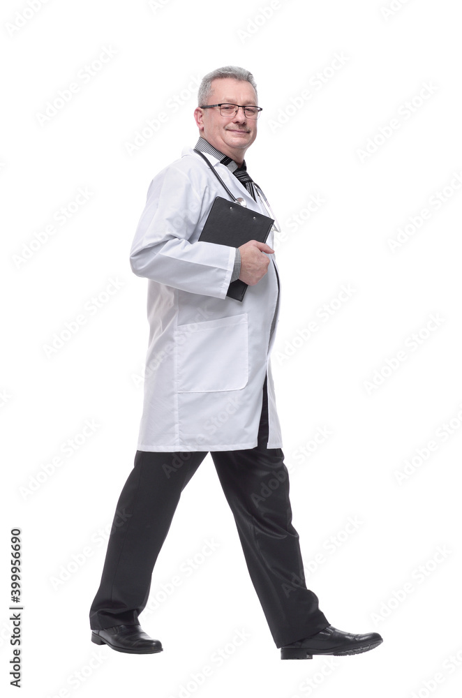 Full length profile shot of a male doctor in a white uniform walking isolated on white background Full length profile shot of a male doctor in a white uniform walking isolated on white background
