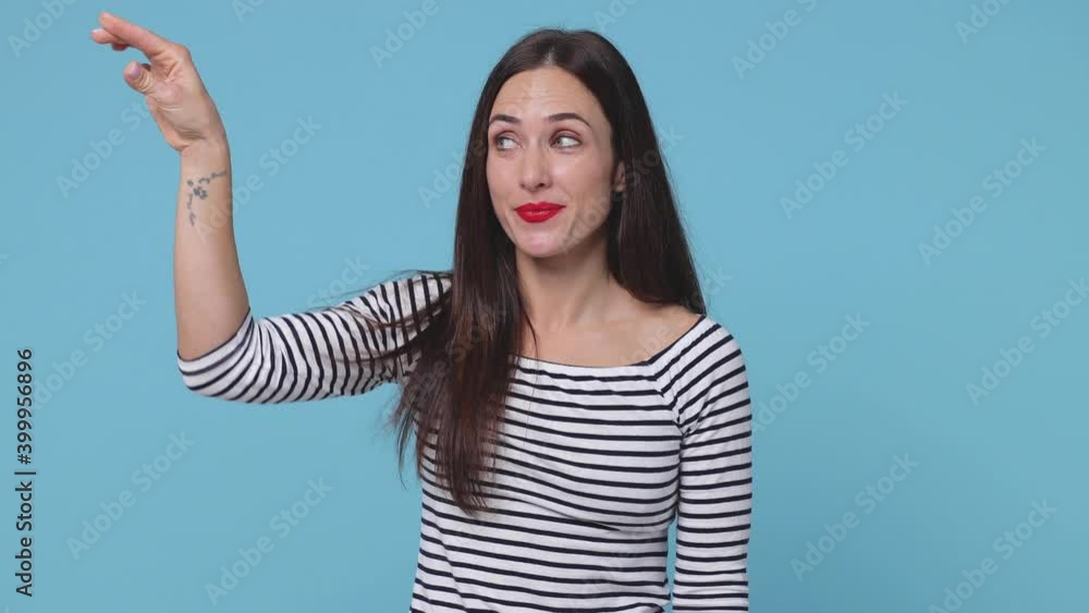 Smiling secret young woman 20s in striped shirt posing isolated on blue background. People lifestyle concept. Saying hush be quiet with finger on lips shhh gesture close her mouth lock throw away key Smiling secret young woman 20s in striped shirt posing isolated on blue background. People lifestyle concept. Saying hush be quiet with finger on lips shhh gesture close her mouth lock throw away key