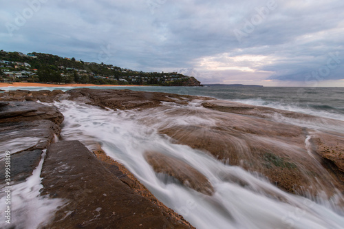 Water flowing on the rocky coastline at Whale Beach, Sydney, Australia.