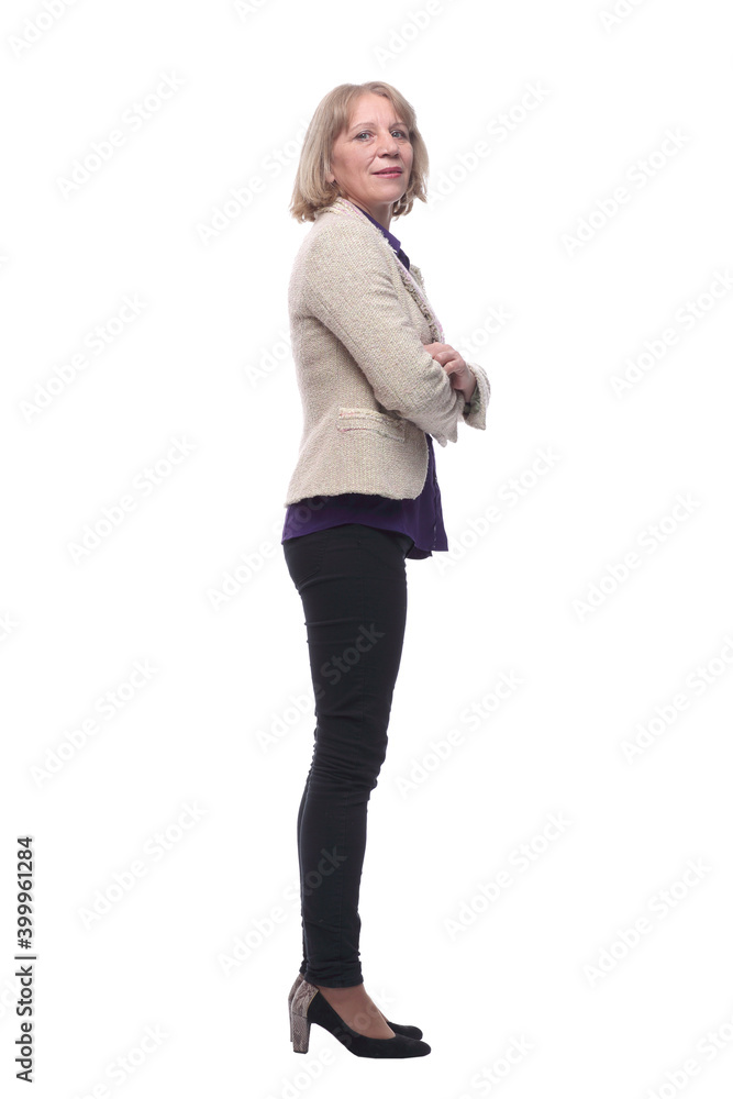 Happy woman in jeans standing and looking at camera. Side view Happy woman in jeans standing and looking at camera. Side view