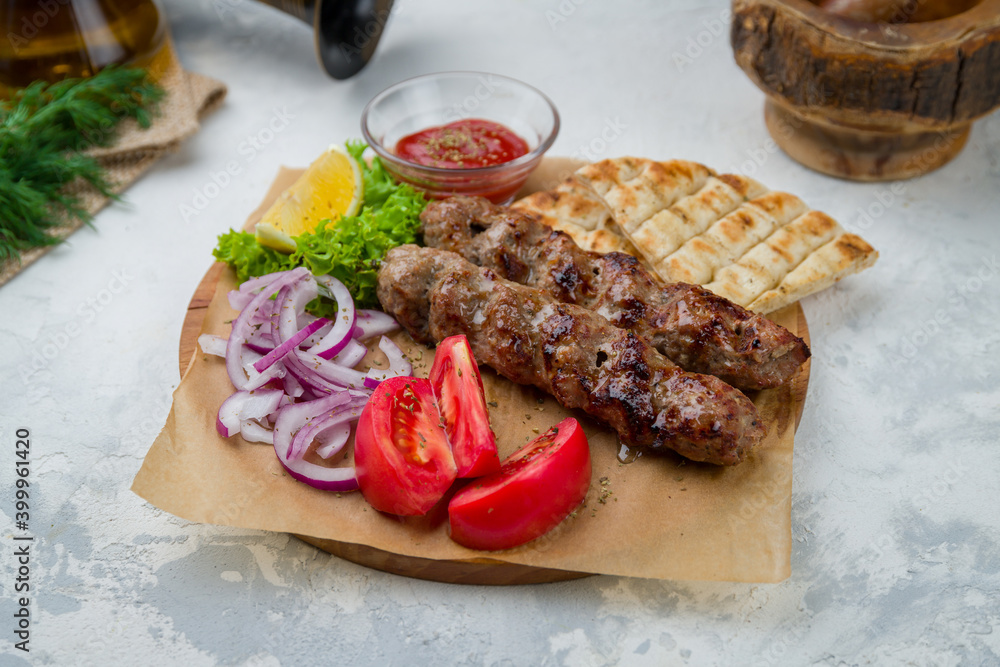 Lamb Lula kebab on the board with sause and pita, greek style kitchen Stock Photo Adobe Stock