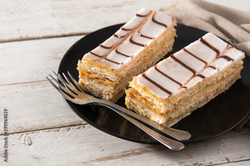 Millefoglie or French mille-feuille on white wooden table