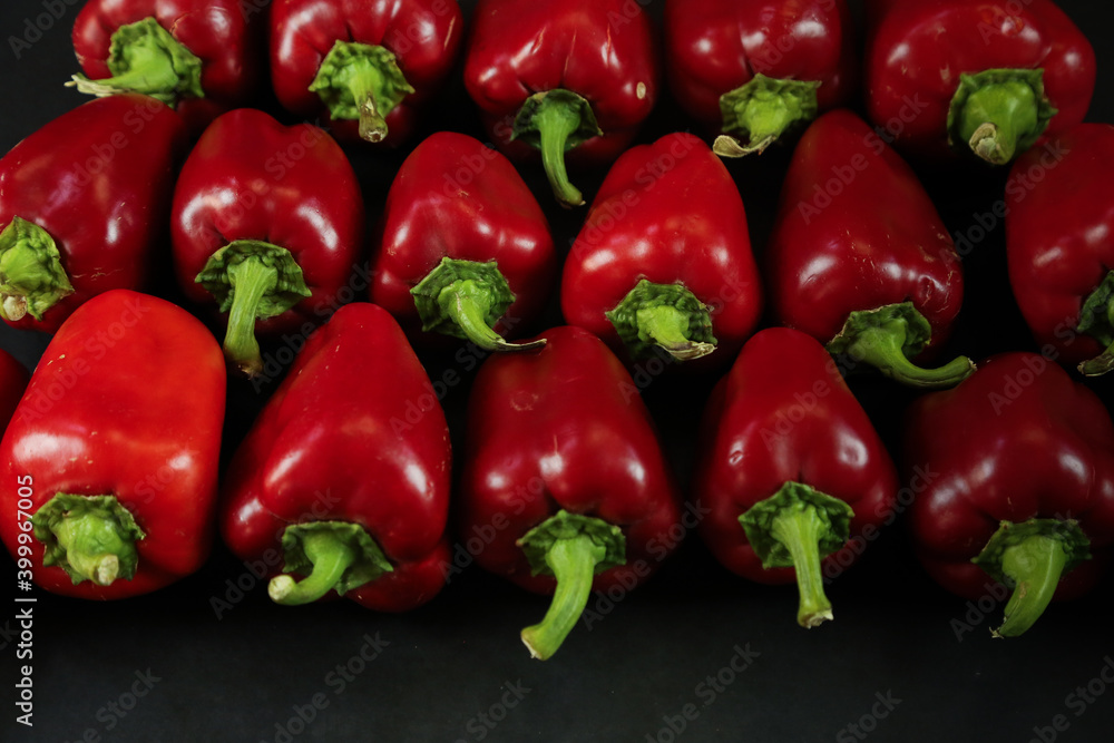 Red peppers on black background