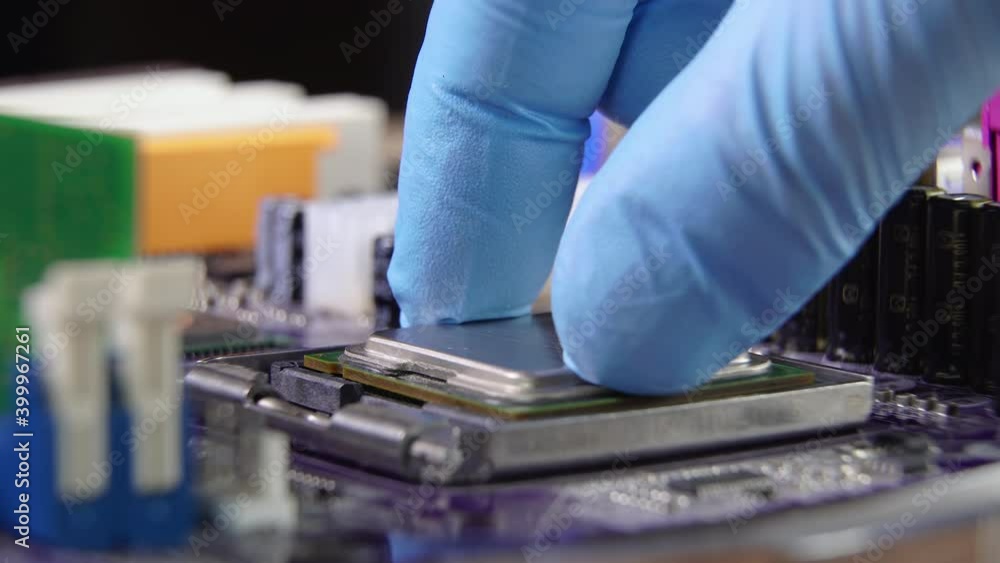 High tech. The process of installing a processor on a computer motherboard. Close-up 4K High tech. The process of installing a processor on a computer motherboard. Close-up 4K