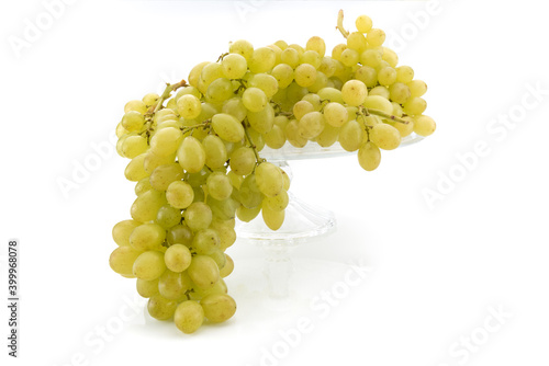 White table grapes, bunches of Uva Italia on raised glass tray isolated on white background