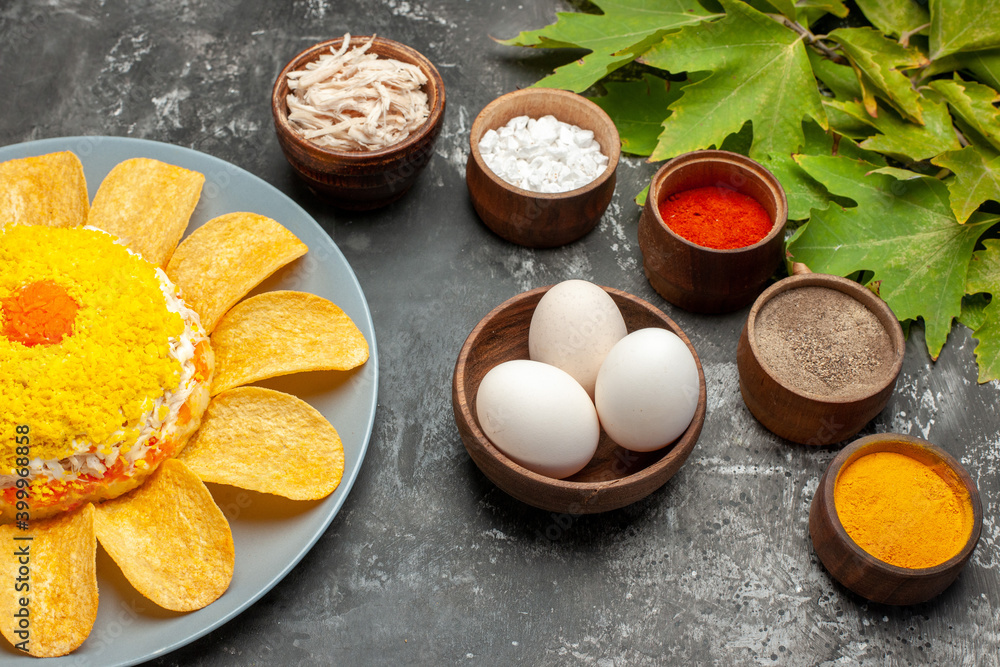 side view of salad with herbs eggs and leaves on the right on dark background side view of salad with herbs eggs and leaves on the right on dark background