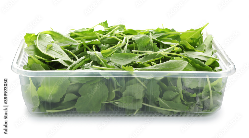 Fresh arugula in plastic container isolated on white Fresh arugula in plastic container isolated on white