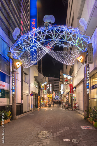 Night view of the illuminated entrance gate of the Sunshine Central Street connecting the east exit of Ikebukuro station decorated for new year. photo