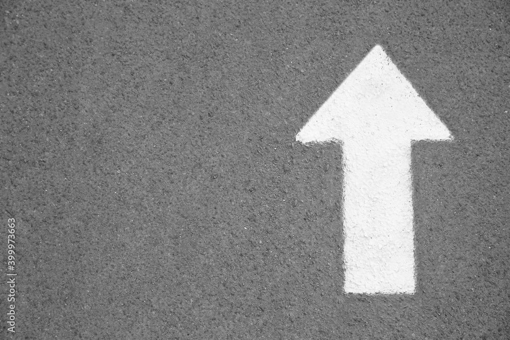 White arrow painted on asphalt, top view. Space for text White arrow painted on asphalt, top view. Space for text