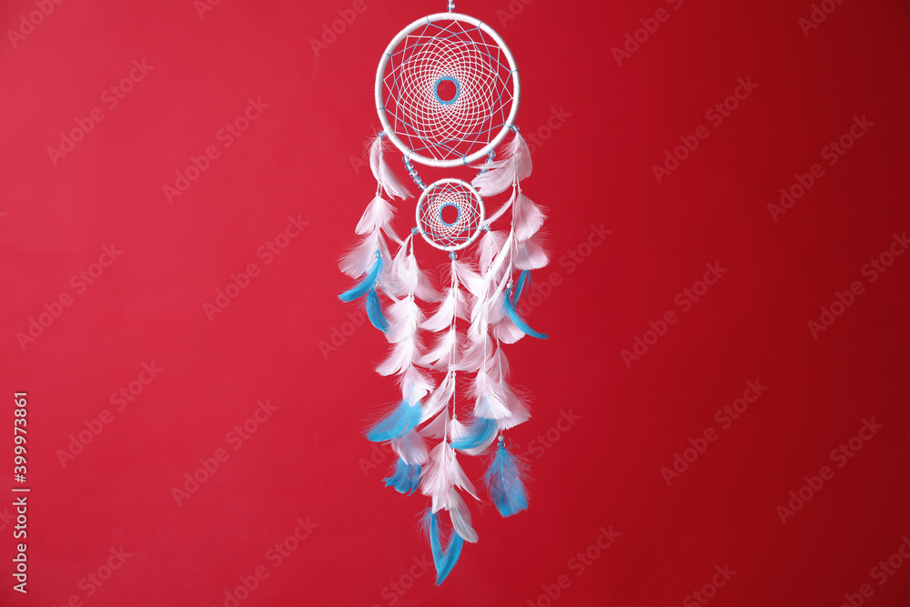 Obraz premium Beautiful dream catcher hanging on red background