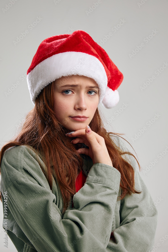portrait of sad girl in christmas hat cropped view portrait of sad girl in christmas hat cropped view