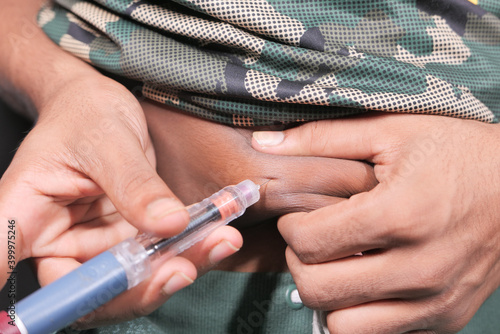 young man hand using insulin pen close up 