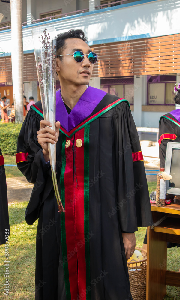 The graduate wore a gown from a university in Thailand. For graduation