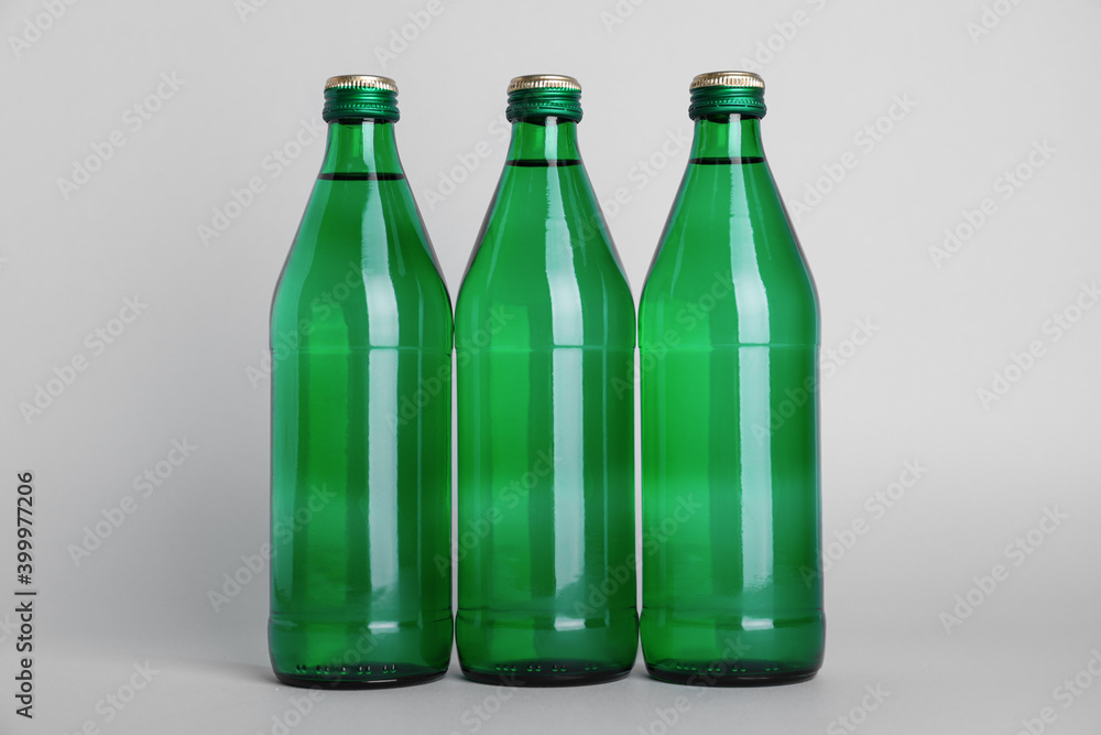 Glass bottles with water on white background Glass bottles with water on white background