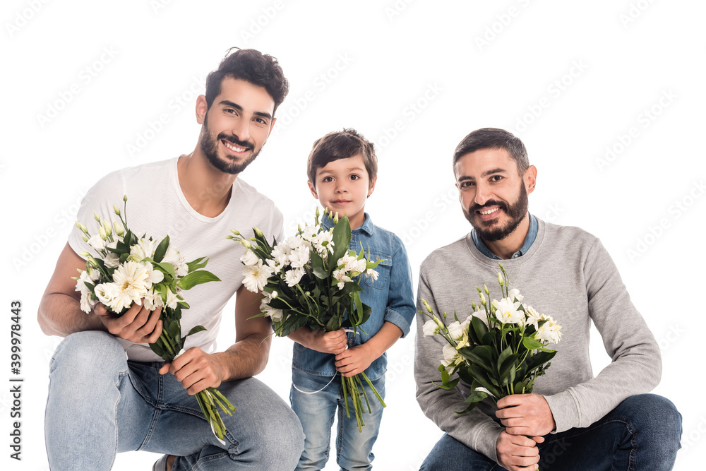 smiling boy with hispanic grandfather and dad holding bouquets isolated on white, three generations of men smiling boy with hispanic grandfather and dad holding bouquets isolated on white, three generations of men