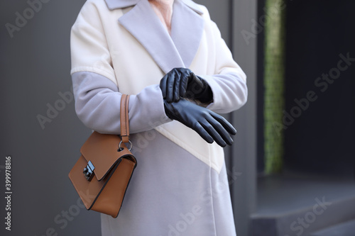 Woman with leather gloves and stylish bag outdoors, closeup