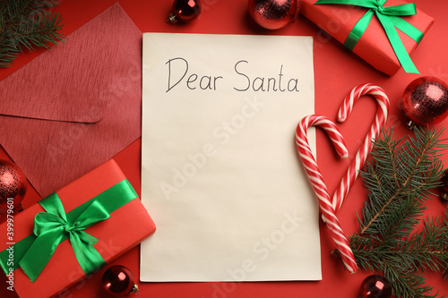 Flat lay composition with letter saying Dear Santa on red background. Space for text photo