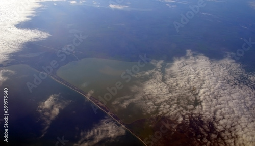 Estuary of the Black Sea. Odessa Region. Bird eye view from airplane window. Clouds panorama from airplane. Flight from Kiev to Sharm El Sheikh, Egypt. photo