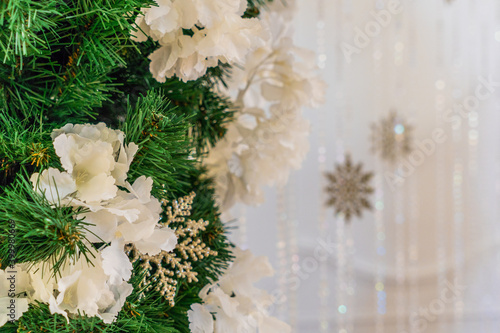Green Christmas tree with white flowers