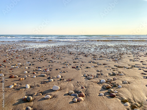 Sand beach with some pebbles and se view background