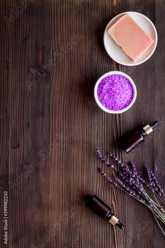 Flat lay of lavender cosmetics - bath salt and essential oil, top view