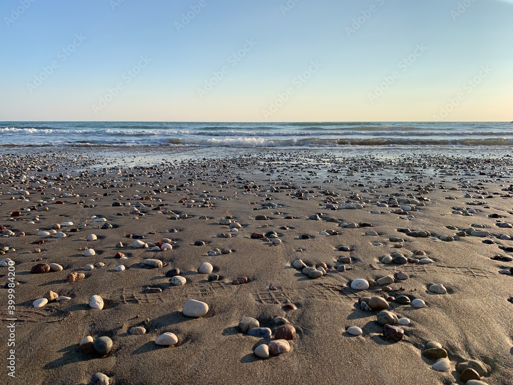 Sand beach with some pebbles and se view background Sand beach with some pebbles and se view background